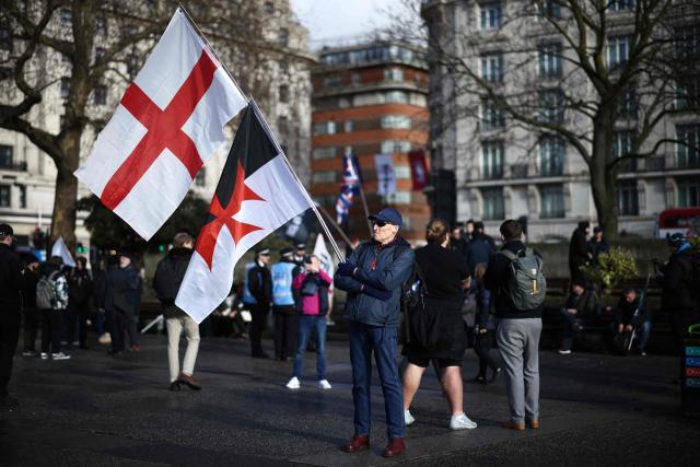 A protester waits for the start of a "Walk With Jesus" march with members of the UK Independence Party (UKIP), in central London on January 31, 2026. (Photo by Henry NICHOLLS / AFP)