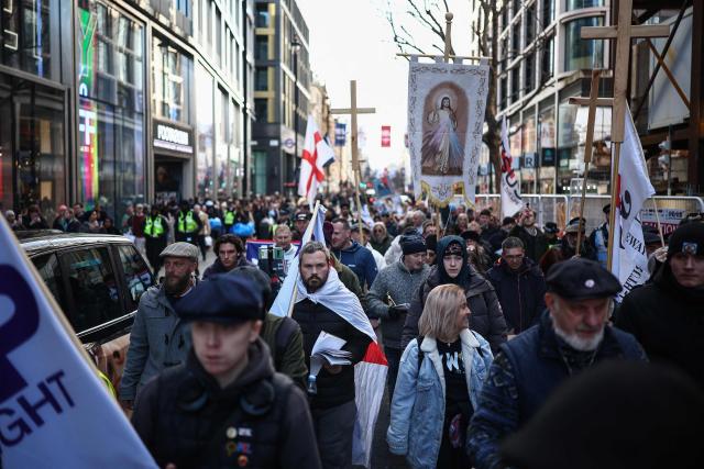 Protesters march through the streets during a "Walk With Jesus" march with members of the UK Independence Party (UKIP), in central London on January 31, 2026. (Photo by HENRY NICHOLLS / AFP)