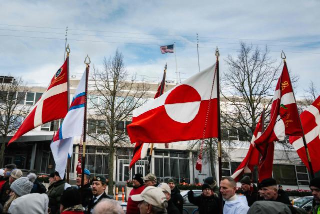 Denmark's Veterans hold Denmark and Greenland's flags as they gather for a "silent demonstration march" from Kastellet in Copenhagen to the American embassy in Copenhagen on January 31, 2026. The march takes place to express dissatisfaction with Trump's statements about NATO soldiers in Afghanistan. (Photo by Emil Nicolai Helms / Ritzau Scanpix / AFP) / Denmark OUT