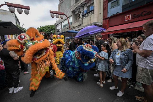 The lion dance is performed during celebrations marking the Chinese Lunar New Year, which welcomes the Year of the Horse, in the Liberdade district of Sao Paulo, Brazil, on January 31, 2026. (Photo by Nelson ALMEIDA / AFP)