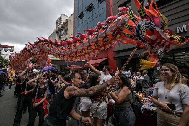 The dragon dance is performed during celebrations marking the Chinese Lunar New Year, which welcomes the Year of the Horse, in the Liberdade district of Sao Paulo, Brazil, on January 31, 2026. (Photo by Nelson ALMEIDA / AFP)
