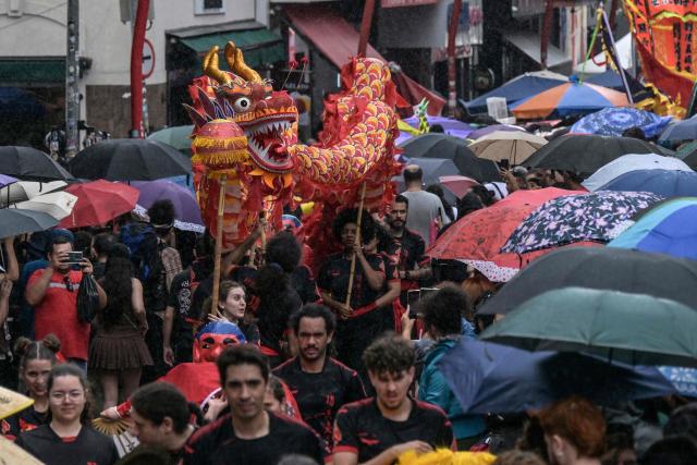The dragon dance is performed during celebrations marking the Chinese Lunar New Year, which welcomes the Year of the Horse, in the Liberdade district of Sao Paulo, Brazil, on January 31, 2026. (Photo by Nelson ALMEIDA / AFP)