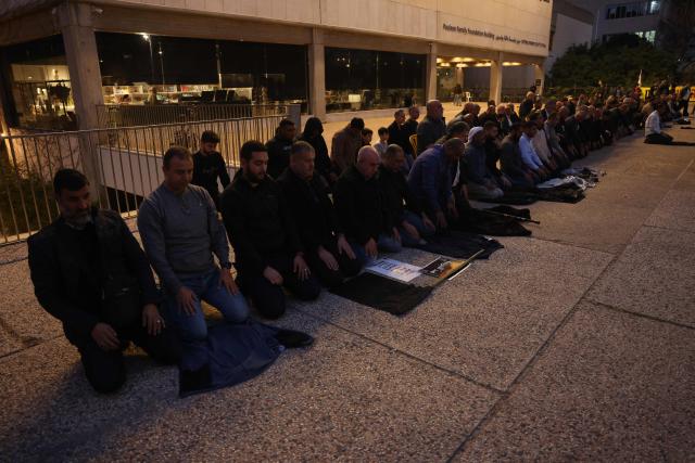 Arab-Israelis pray during a demonstration in Tel-Aviv on January 31, 2026, to draw attention to the rising crime rates in their community. (Photo by AHMAD GHARABLI / AFP)