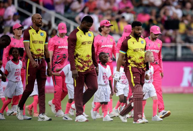 West Indies' Shai Hope (C) leads his teammates and mascots onto the field ahead of the third Twenty20 international cricket match between South Africa and West Indies at The DP World Wanderers Stadium in Johannesburg on January 31, 2026. (Photo by Marco Longari / AFP)