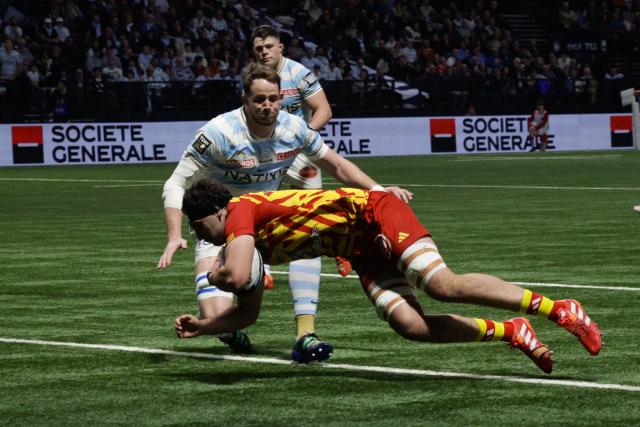 Perpignan's French flanker Max Hicks dives to score a try during the French Top14 rugby union match between Racing 92 and USA Perpignan at the Paris La Defense Arena in Nanterre, on the outskirts of Paris on January 31, 2026. (Photo by GEOFFROY VAN DER HASSELT / AFP)