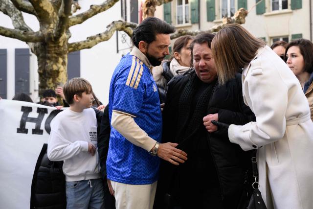 Christian Pidoux (L), father of victim Trystan, who died in the fire comforts the mother of victim as they take part to a silent march organized in memory of some of the victims of the Crans Montana deadly New Year's Eve fire, in Lutry, near Lausanne, on January 31, 2026. The fire on January 1 at the bar "Le Constellation" left 40 people dead -- including nine French and six Italian nationals -- and injured 116 others, most of them teenagers. (Photo by Harold CUNNINGHAM / AFP)