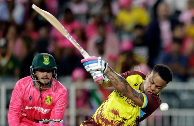 West Indies' Shimron Hetmyer (R) plays a shot as South Africa's wicketkeeper Quinton de Kock looks on during the third Twenty20 international cricket match between South Africa and West Indies at The DP World Wanderers Stadium in Johannesburg on January 31, 2026. (Photo by Marco Longari / AFP)