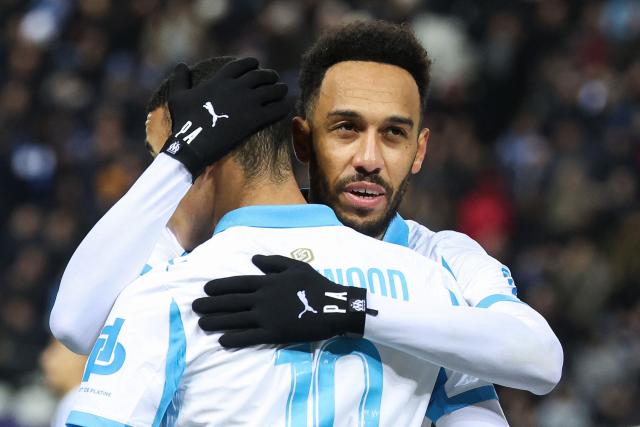 Marseille's Gabonese forward #97 Pierre-Emerick Aubameyang (R) celebrates scoring his team's second goal with Marseille's English forward #10 Mason Greenwood during the French L1 football match between Paris FC and Olympique de Marseille at the Stade Jean-Bouin in Paris on January 31, 2026. (Photo by Alain JOCARD / AFP)