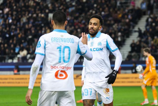 Marseille's Gabonese forward #97 Pierre-Emerick Aubameyang (R) celebrates scoring his team's second goal with Marseille's English forward #10 Mason Greenwood during the French L1 football match between Paris FC and Olympique de Marseille at the Stade Jean-Bouin in Paris on January 31, 2026. (Photo by Alain JOCARD / AFP)