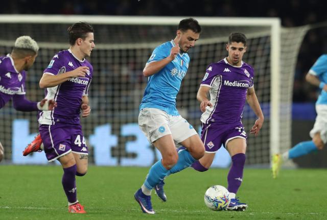 Napoli's Macedonian midfielder #20 Eljif Elmas fights for the ball with Fiorentina's Israeli forward #19 Manor Solomon (R) and Fiorentina's Italian midfielder #44 Nicolo Fagioli (L)  during the Italian Serie A football match between SSC Napoli and ACF Fiorentina at the Diego Armando Maradona Stadium in Naples on January 31, 2026. (Photo by CARLO HERMANN / AFP)