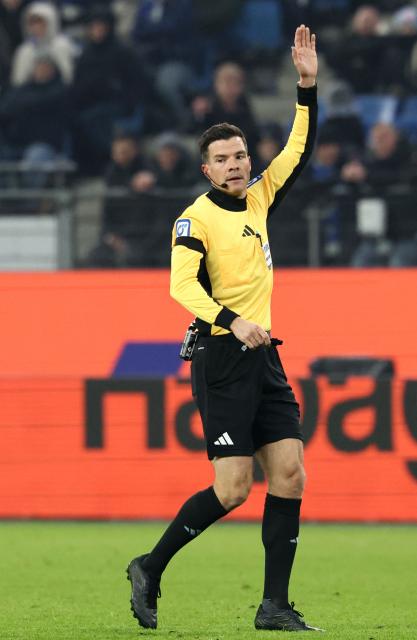 German referee Harm Osmers reacts during the German first division Bundesliga football match between Hamburger SV and FC Bayern Munich in Hamburg, northern Germany on January 31, 2026. (Photo by IBRAHIM OT / AFP) / DFL REGULATIONS PROHIBIT ANY USE OF PHOTOGRAPHS AS IMAGE SEQUENCES AND/OR QUASI-VIDEO
