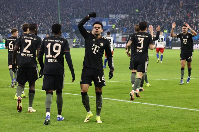 Bayern Munich's Colombian forward #14 Luis Diaz (C) celebrates scoring his team's second goal with team mates and fans during the German first division Bundesliga football match between Hamburger SV and FC Bayern Munich in Hamburg, northern Germany on January 31, 2026. (Photo by Ibrahim OT / AFP) / DFL REGULATIONS PROHIBIT ANY USE OF PHOTOGRAPHS AS IMAGE SEQUENCES AND/OR QUASI-VIDEO