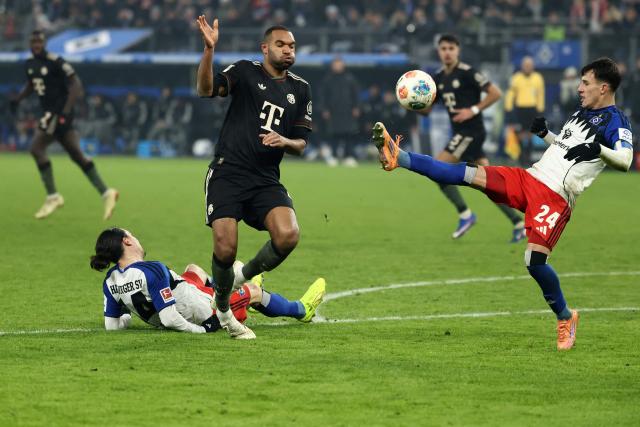 Bayern Munich's German defender #04 Jonathan Tah (C) vies for the ball with Hamburg's Argentine midfielder #24 Nicolas Capaldo (R) and Hamburg's French forward #14 Rayan Philippe during the German first division Bundesliga football match between Hamburger SV and FC Bayern Munich in Hamburg, northern Germany on January 31, 2026. (Photo by IBRAHIM OT / AFP) / DFL REGULATIONS PROHIBIT ANY USE OF PHOTOGRAPHS AS IMAGE SEQUENCES AND/OR QUASI-VIDEO