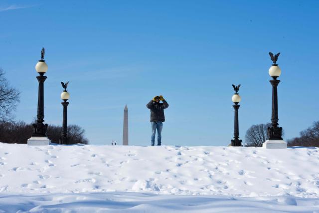 A person takes a photo with a cell phone on the National Mall in Washington, DC, on January 31, 2026. (Photo by Aaron Schwartz / AFP)