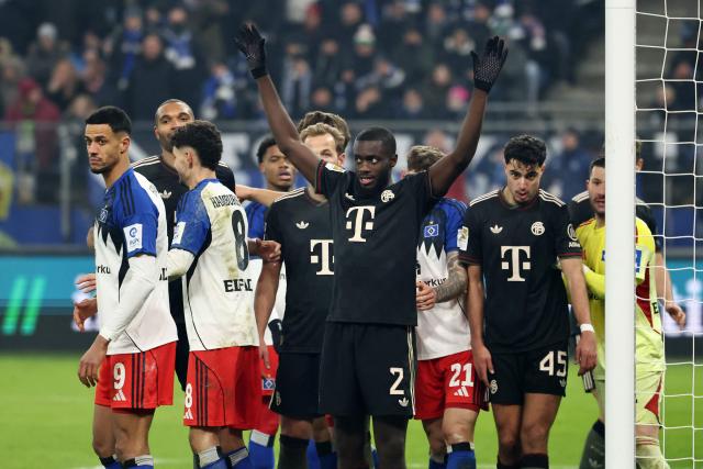 Bayern Munich's French defender #02 Dayot Upamecano (C) reacts next to Bayern's and Hamburg's players during the German first division Bundesliga football match between Hamburger SV and FC Bayern Munich in Hamburg, northern Germany on January 31, 2026. (Photo by IBRAHIM OT / AFP) / DFL REGULATIONS PROHIBIT ANY USE OF PHOTOGRAPHS AS IMAGE SEQUENCES AND/OR QUASI-VIDEO