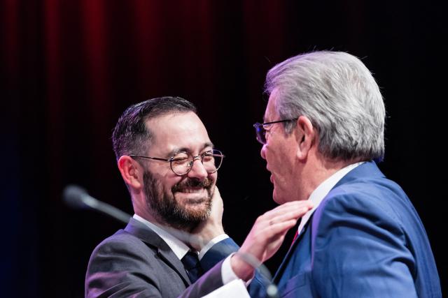 Founder of French left-wing La France Insoumise (LFI) party Jean-Luc Melenchon (R) greets French MP and member of the La France Insoumise (LFI) party David Guiraud (L) during latter's campaign rally as a candidate in the municipal elections in Roubaix, northern France, on January 31, 2026. (Photo by Sameer Al-DOUMY / AFP)