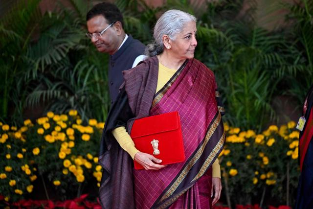 India's Finance Minister Nirmala Sitharaman (R) leaves the Finance Ministry office to present the annual budget to the parliament at the Kartavya Bhawan in New Delhi on February 1, 2026. (Photo by Sajjad HUSSAIN / AFP)
