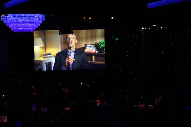 Fomer US president Barack Obama is seen on a screen giving a salute to attendees of the Recording Academy and Clive Davis' Salute To Industry Icons pre-Grammy gala at the Beverly Hilton hotel in Beverly Hills, California on January 31, 2026. (Photo by Patrick T. Fallon / AFP)