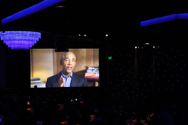 Fomer US president Barack Obama is seen on a screen giving a salute to attendees of the Recording Academy and Clive Davis' Salute To Industry Icons pre-Grammy gala at the Beverly Hilton hotel in Beverly Hills, California on January 31, 2026. (Photo by Patrick T. Fallon / AFP)