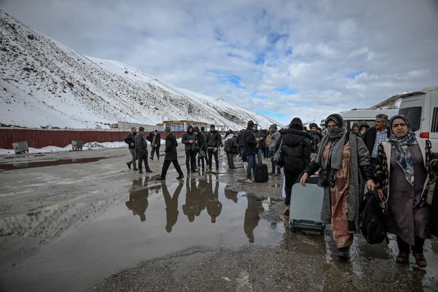 Iranian nationals arrive in Turkey through the Razi-Kapiköy border crossing, north-eastern Turkey on February 1, 2026. Iran's supreme leader Ayatollah Ali Khamenei warned on February 1, 2026 of a "regional war" if the United States attacked following heavy military deployments by Washington in the Gulf. (Photo by Ozan KOSE / AFP)