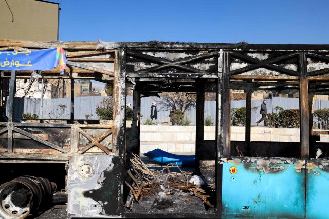 This picture shows a destroyed bus in Tehran's Haftome-tir Square on February 1, 2026. Iran's supreme leader Ayatollah Ali Khamenei said on February 1 that recent anti-government protests that saw killings and vandalism were akin to "a coup". Protests over economic grievances began in late December, but turned into a mass movement against the Islamic republic, with huge street demonstrations for several days from January 8 -- the day the shutdown was imposed. (Photo by ATTA KENARE / AFP)