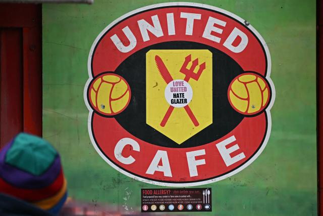 An anti-Glazer sticker is seen on a cafe window outside the ground ahead of the English Premier League football match between Manchester United and Fulham at Old Trafford in Manchester, north west England, on February 1, 2026. (Photo by Paul ELLIS / AFP)