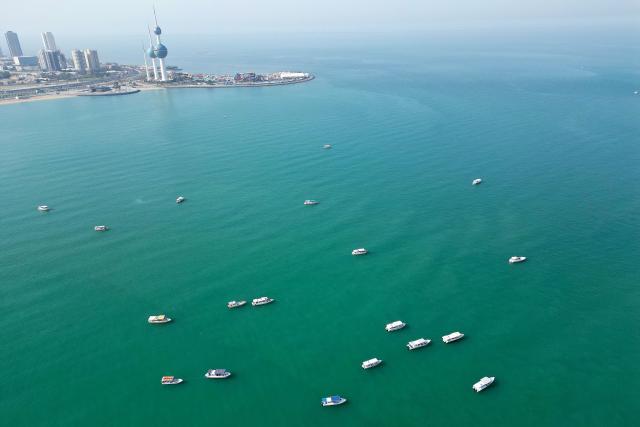 An aerial view shows fishing boats in the Gulf waters of Kuwait City on February 1, 2026. (Photo by YASSER AL-ZAYYAT / AFP)