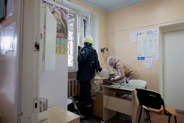 A rescue worker clears debris in a damaged maternity hospital following a Russian strike in Zaporizhzhia on February 1, 2026, amid the Russian invasion of Ukraine. Russian attacks on Ukraine overnight and early on February 1, 2026 killed at least two people and injured seven others, regional authorities said. Among the attacks was a drone strike on a maternity hospital in the southern city of Zaporizhzhia that injured two women undergoing a medical examination, the region's governor and rescuers said. (Photo by Tetiana DZHAFAROVA / AFP)