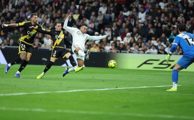 Real Madrid's French forward #10 Kylian Mbappe (3L) attempts to score next to Rayo Vallecano's French defender #24 Florian Lejeune and Rayo Vallecano's Spanish defender #03 Pep Chavarria during the Spanish league football match between Real Madrid CF and Rayo Vallecano at the Santiago Bernabeu stadium in Madrid on February 1, 2026. (Photo by Thomas COEX / AFP)