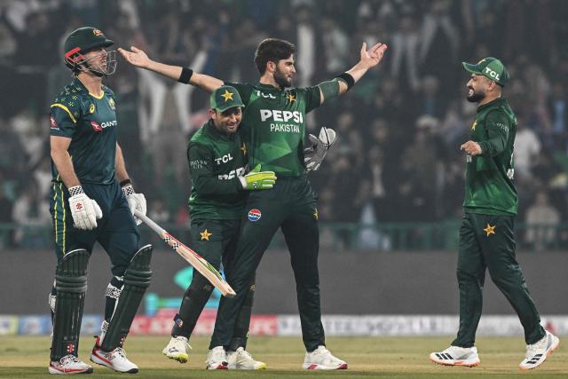 Pakistan's Shaheen Shah Afridi (2R) celebrates with teammates after taking the wicket of Australia's captain Mitchell Marsh (L) during the third Twenty20 international cricket match between Pakistan and Australia at the Gaddafi Stadium in Lahore on February 1, 2026. (Photo by Arif ALI / AFP)