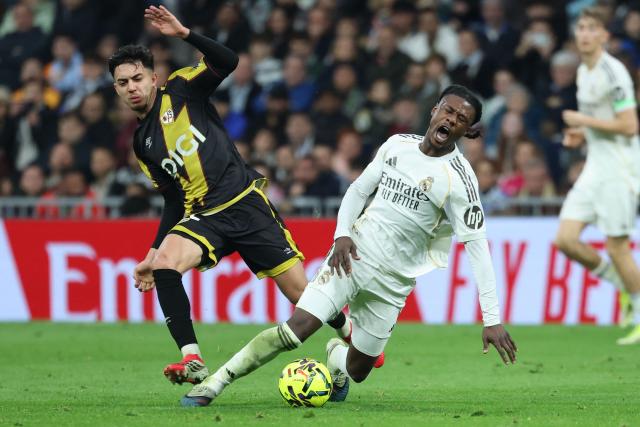Rayo Vallecano's Moroccan forward #12 Ilias Akhomach and Real Madrid's French midfielder #06 Eduardo Camavinga fight for the ball during the Spanish league football match between Real Madrid CF and Rayo Vallecano at the Santiago Bernabeu stadium in Madrid on February 1, 2026. (Photo by Thomas COEX / AFP)