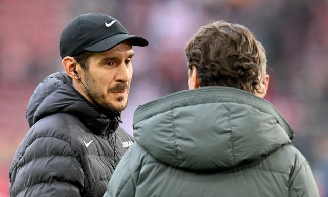 Freiburg's German head coach Julian Schuster (L) gives an interview prior to the German first division Bundesliga football match between VfB Stuttgart and SC Freiburg in Stuttgart, southern Germany, on February 1, 2026. (Photo by THOMAS KIENZLE / AFP) / DFL REGULATIONS PROHIBIT ANY USE OF PHOTOGRAPHS AS IMAGE SEQUENCES AND/OR QUASI-VIDEO