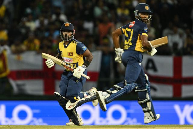 Sri Lanka's Charith Asalanka (L) and Pavan Rathnayake run between the wickets during the second Twenty20 international cricket match between Sri Lanka and England at the Pallekele International Cricket Stadium in Kandy on February 1, 2026. (Photo by Ishara S. KODIKARA / AFP)