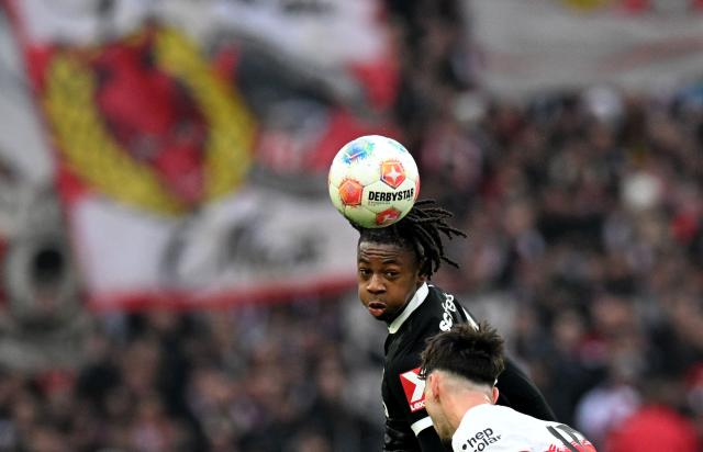Freiburg's Swiss midfielder #44 Johan Manzambi (top) and Stuttgart's German midfielder #16 Atakan Karazor vie for the ball during the German first division Bundesliga football match between VfB Stuttgart and SC Freiburg in Stuttgart, southern Germany, on February 1, 2026. (Photo by THOMAS KIENZLE / AFP) / DFL REGULATIONS PROHIBIT ANY USE OF PHOTOGRAPHS AS IMAGE SEQUENCES AND/OR QUASI-VIDEO
