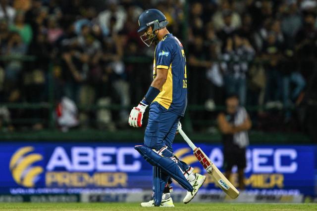Sri Lanka's captain Dasun Shanaka walks back to the pavilion after his dismissal during the second Twenty20 international cricket match between Sri Lanka and England at the Pallekele International Cricket Stadium in Kandy on February 1, 2026. (Photo by Ishara S. KODIKARA / AFP)