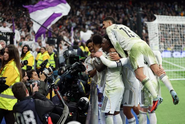 Real Madrid players celebrate their second goal scored by Real Madrid's French forward #10 Kylian Mbappe during the Spanish league football match between Real Madrid CF and Rayo Vallecano at the Santiago Bernabeu stadium in Madrid on February 1, 2026. (Photo by Thomas COEX / AFP)