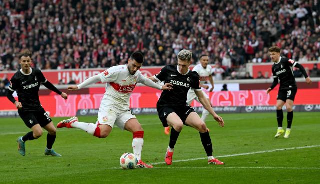 Stuttgart's German forward #26 Deniz Undav (C-L) and Freiburg's German defender #28 Matthias Ginter (C-R) vie for the ball during the German first division Bundesliga football match between VfB Stuttgart and SC Freiburg in Stuttgart, southern Germany, on February 1, 2026. (Photo by THOMAS KIENZLE / AFP) / DFL REGULATIONS PROHIBIT ANY USE OF PHOTOGRAPHS AS IMAGE SEQUENCES AND/OR QUASI-VIDEO