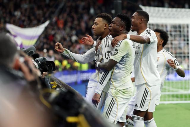 TOPSHOT - Real Madrid's French forward #10 Kylian Mbappe (L) celebrates scoring his team's second goal during the Spanish league football match between Real Madrid CF and Rayo Vallecano at the Santiago Bernabeu stadium in Madrid on February 1, 2026. (Photo by Thomas COEX / AFP)