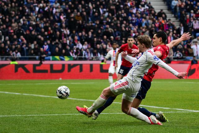Lyon's Czech midfielder #10 Pavel Sulc (L) fights for the ball with Lille's Algerian defender #23 Aissa Mandi during the French L1 football match between Olympique Lyonnais (OL) and Lille LOSC at the Groupama Stadium in Decines-Charpieu, central-eastern France, on February 1, 2026. (Photo by Olivier CHASSIGNOLE / AFP)
