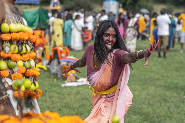 A Hindu devotee reacts while dancing during a ritual at the annual Thaipoosam Kavadi festival in Durban, on February 1, 2026. The Thaipoosam Kavadi festival is a Hindu celebration honoring Lord Murugan, marked by prayers, offerings, and acts of devotion. (Photo by Rajesh JANTILAL / AFP)