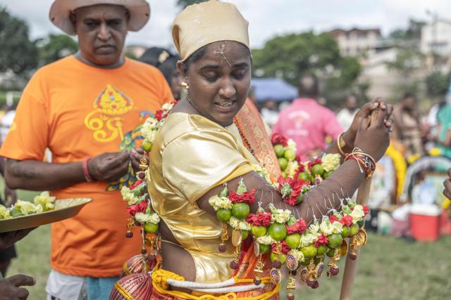 A Hindu devotee takes part in an ritual, with small hooks and offerings attached to his body, during the annual Thaipoosam Kavadi festival in Durban, on February 1, 2026. The Thaipoosam Kavadi festival is a Hindu celebration honoring Lord Murugan, marked by prayers, offerings, and acts of devotion. (Photo by Rajesh JANTILAL / AFP)