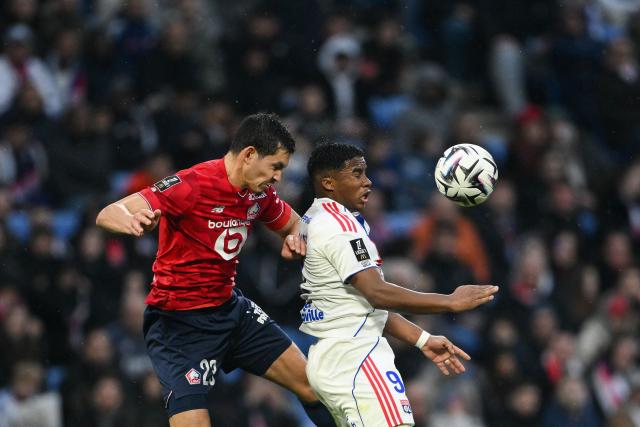 Lille's Algerian defender #23 Aissa Mandi (L) fights for the ball with Lyon's Brazilian forward #09 Endrick during the French L1 football match between Olympique Lyonnais (OL) and Lille LOSC at the Groupama Stadium in Decines-Charpieu, central-eastern France, on February 1, 2026. (Photo by Olivier CHASSIGNOLE / AFP)
