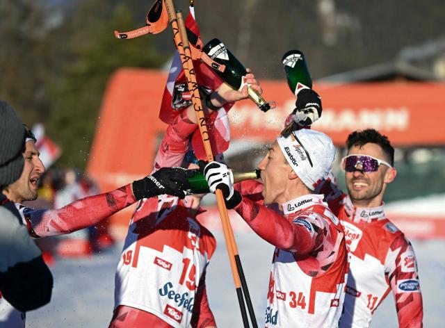 Austria's Mario Seidl (C) celebrates with team mates after the FIS Nordic Combined World Cup in Seefeld, Austria, on February 1, 2026. (Photo by BARBARA GINDL / APA / AFP) / Austria OUT