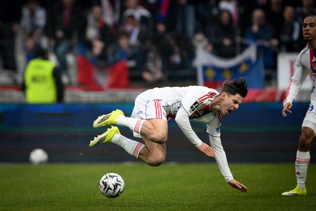 Lyon's French forward #45 Remi Himbert falls during the French L1 football match between Olympique Lyonnais (OL) and Lille LOSC at the Groupama Stadium in Decines-Charpieu, central-eastern France, on February 1, 2026. (Photo by OLIVIER CHASSIGNOLE / AFP)