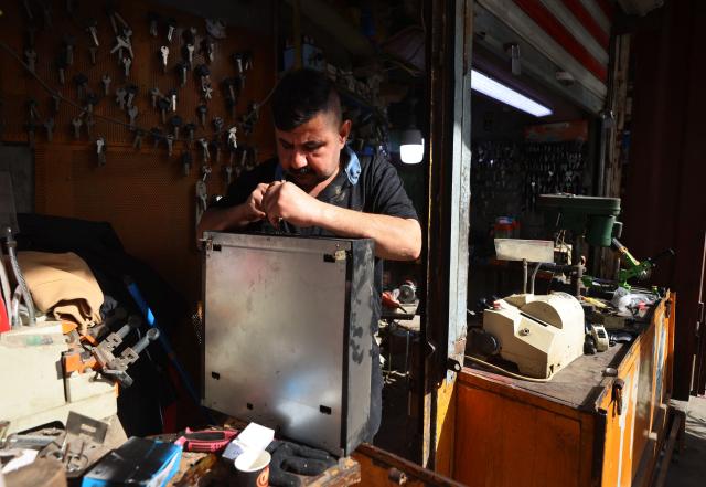 An Iraqi man works inside his key-making workshop in the Al-Ukaidad market on Al-Rashid Street in central Baghdadon February 1, 2026. (Photo by AHMAD AL-RUBAYE / AFP)