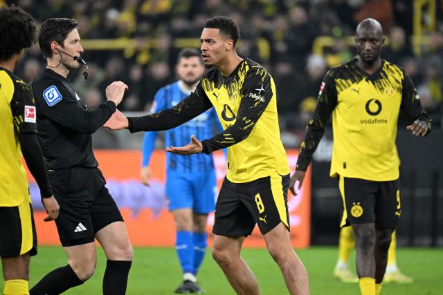 Dortmund's German midfielder #08 Felix Nmecha (C) reacts with the referee during the German first division Bundesliga football match between Borussia Dortmund and Heidenheim in Dortmund, western Germany, on February 1, 2026. (Photo by UWE KRAFT / AFP) / DFL REGULATIONS PROHIBIT ANY USE OF PHOTOGRAPHS AS IMAGE SEQUENCES AND/OR QUASI-VIDEO