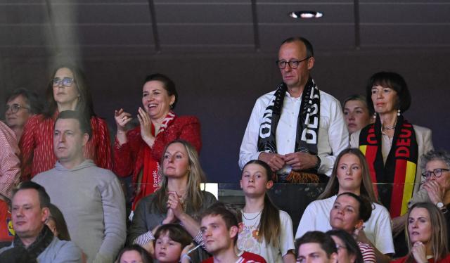 German Chancellor Friedrich Merz (back row 2R), his wife Charlotte Merz  (R), Danish Prime Minister Mette Frederiksen (2L) and Queen Mary of Denmark (L) watch from the stands the Men's EHF Euro 2026 final handball match Denmark vs Germany in Herning, Denmark, on February 1, 2026. (Photo by Jonathan Nackstrand / AFP)