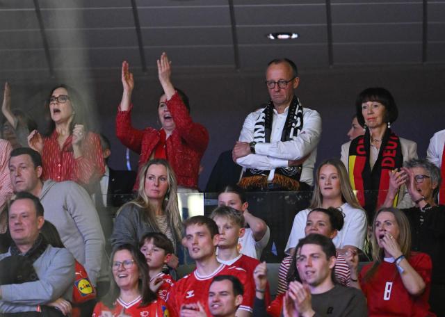 German Chancellor Friedrich Merz (back row 2R), his wife Charlotte Merz  (R), Danish Prime Minister Mette Frederiksen (2L) and Queen Mary of Denmark (L) react as they watch from the stands the Men's EHF Euro 2026 final handball match Denmark vs Germany in Herning, Denmark, on February 1, 2026. (Photo by Jonathan Nackstrand / AFP)