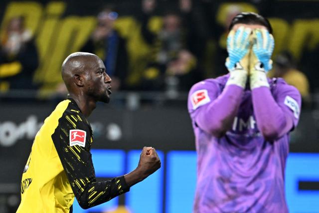 Dortmund's Guinean forward #09 Serhou Guirassy celebrates after scoring a goal past Heidenheim's German goalkeeper #41 Diant Ramaj (R) during the German first division Bundesliga football match between Borussia Dortmund and Heidenheim in Dortmund, western Germany, on February 1, 2026. (Photo by UWE KRAFT / AFP) / DFL REGULATIONS PROHIBIT ANY USE OF PHOTOGRAPHS AS IMAGE SEQUENCES AND/OR QUASI-VIDEO