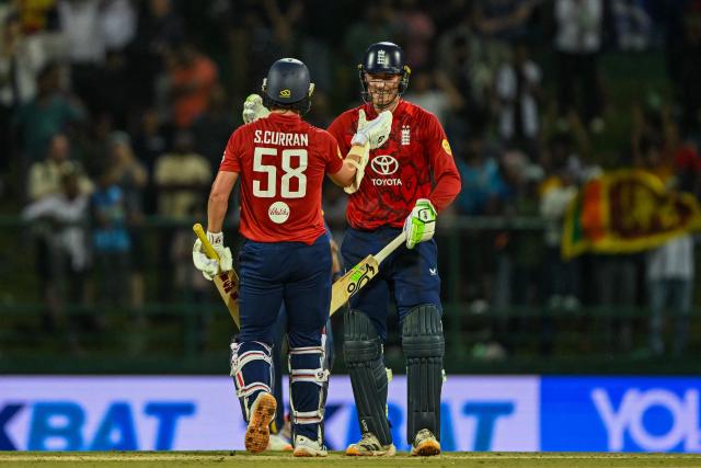 England's Tom Banton (R) and Sam Curran celebrates after winning during the second Twenty20 international cricket match between Sri Lanka and England at the Pallekele International Cricket Stadium in Kandy on February 1, 2026. (Photo by Ishara S. KODIKARA / AFP)